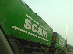 [truck with the word "Scam" on it]